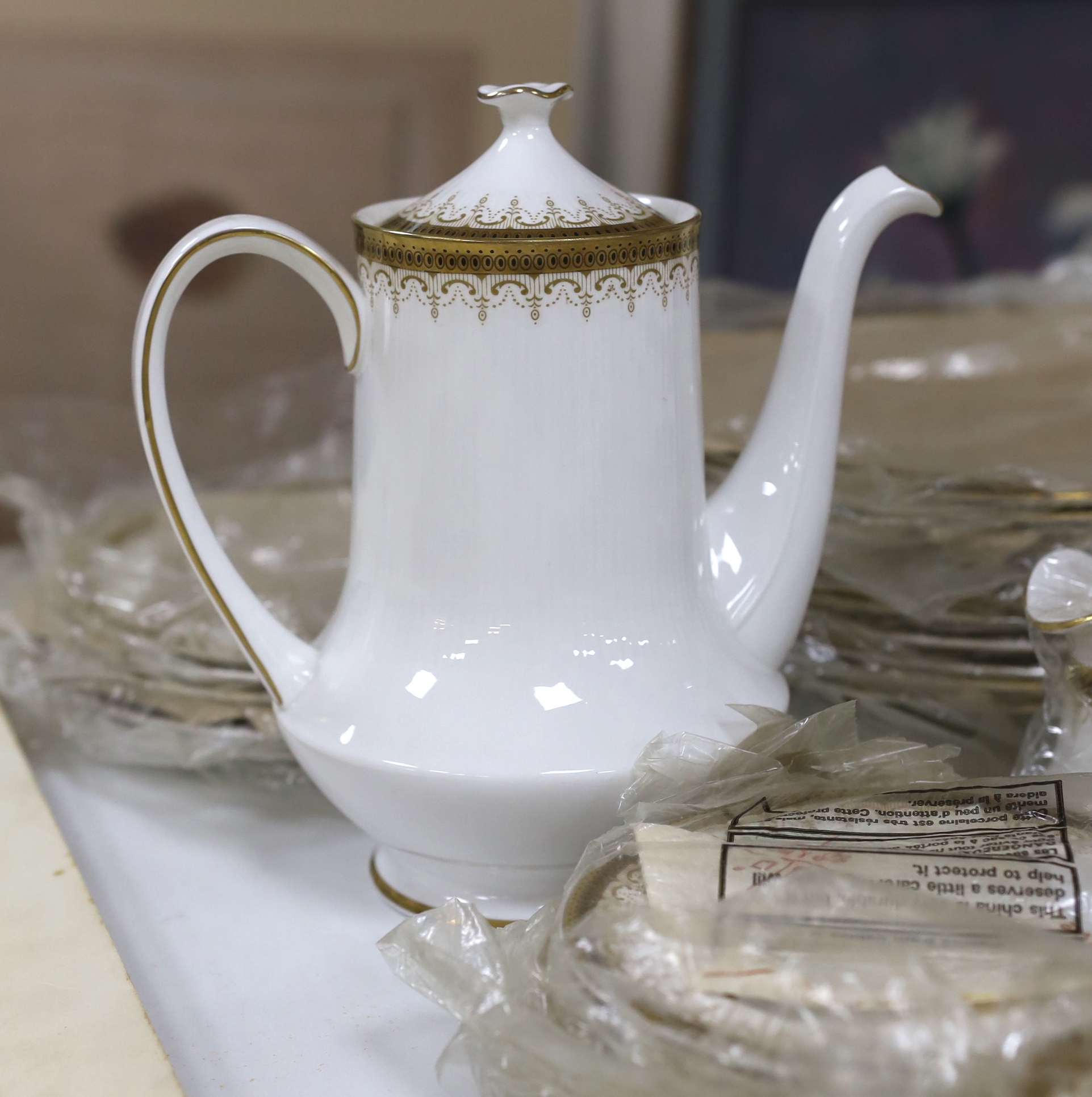 A Paragon Athena pattern blue and gilt tea service including three lidded tureens, oval platter and dinner plates, the largest 38cm wide